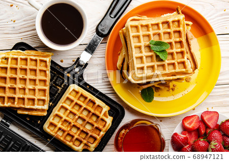 Flat lay view at Belgian Waffles on cast skillet Flat lay view at Belgian Waffles on cast skillet 68947121