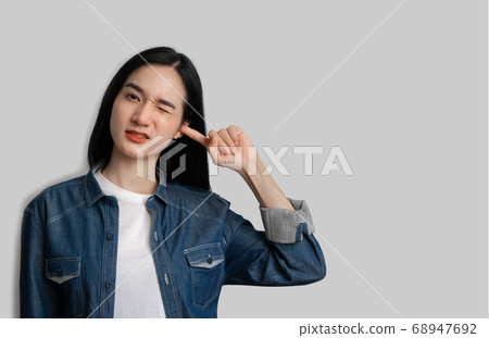 Woman closed her ears not to listen on gray 68947692