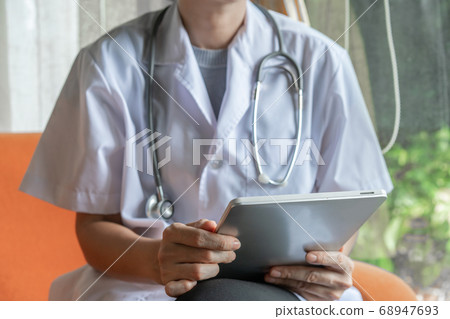 Doctor holding tablet in telemedical concept 68947693