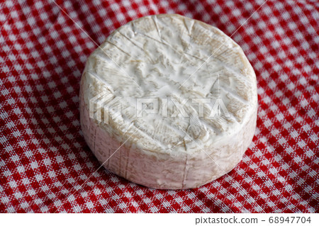 Camembert cheese on red table napkin Camembert cheese on red table napkin 68947704