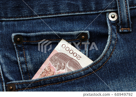 Banknote money twenty thousand Cambodian Riel in the pocket of blue jeans. Banknote money twenty thousand Cambodian Riel in the pocket of blue jeans. 68949792