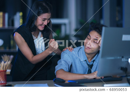 Businesspeople in the office at night working 68950053