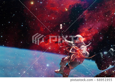 Astronaut. Nebula, cluster of stars. Elements of this image furnished by NASA. Astronaut. Nebula, cluster of stars. Elements of this image furnished by NASA. 68951955