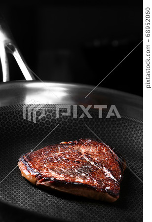 Beef Steak is preparing on the dark pan Beef Steak is preparing on the dark pan 68952060