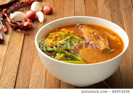 Sour soup with fried fish and mixed Vegetable. 68953036