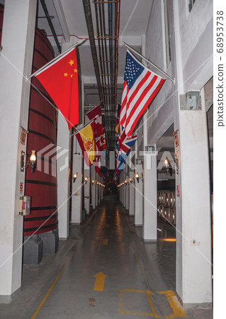 Corridor with tanks for wine storage and flags 68953738