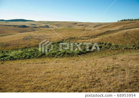 Rural lowlands with dry bushes covering the hills Rural lowlands with dry bushes covering the hills 68953954