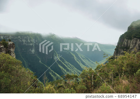 Fortaleza Canyon with rocky cliffs on foggy day 68954147