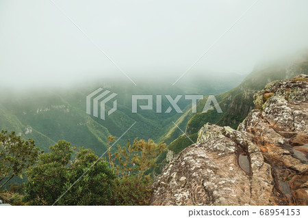 Fortaleza Canyon with rocky cliffs on foggy day Fortaleza Canyon with rocky cliffs on foggy day 68954153