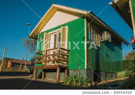 Charming small wooden chalet at sunrise 68954200