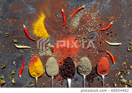 silver spoon with various spices 68954402