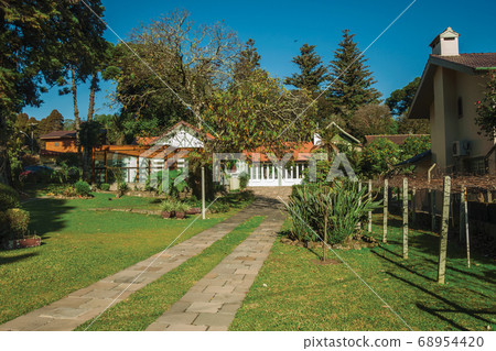 Entrance with garden and pathway in a house Entrance with garden and pathway in a house 68954420