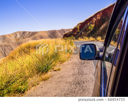 Driving a car through the scenic landscapes of Madagascar highlands Driving a car through the scenic landscapes of Madagascar highlands 68954735