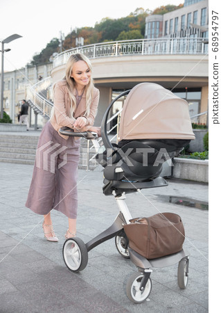 Lovely mother with a pram Lovely mother with a pram 68954797