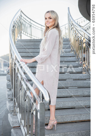 Beautiful young woman posing standing Beautiful young woman posing standing 68954798