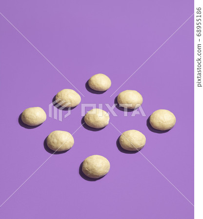Bread buns unbaked symmetrically aligned. Raw 68955186
