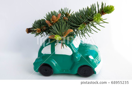 Green toy car-piggy Bank, carrying a Christmas tree on the roof Green toy car-piggy Bank, carrying a Christmas tree on the roof 68955235