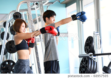 Men and women taking martial arts (boxing) lessons Men and women taking martial arts (boxing) lessons 68957505