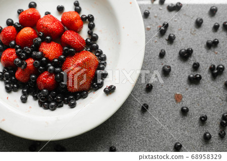 Many juicy fresh ripe red berries and blackberries Many juicy fresh ripe red berries and blackberries 68958329