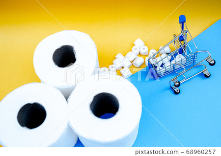 Toilet paper and shopping cart isolated on a blue background Toilet paper and shopping cart isolated on a blue background 68960257