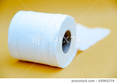 Toilet paper isolated on a yellow background Toilet paper isolated on a yellow background 68960259