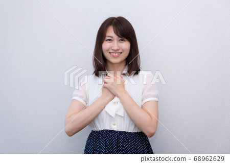 A woman smiling with her hands 68962629
