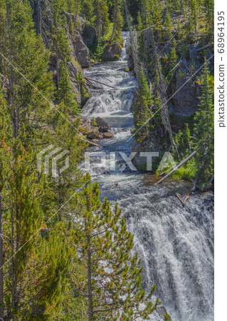 The beautiful Kepler Cascades Waterfall on the Firehole River. Southwestern Yellowstone National Park in the Rocky Mountains, Park County, Wyoming The beautiful Kepler Cascades Waterfall on the Firehole River. Southwestern Yellowstone National Park in the Rocky Mountains, Park County, Wyoming 68964195
