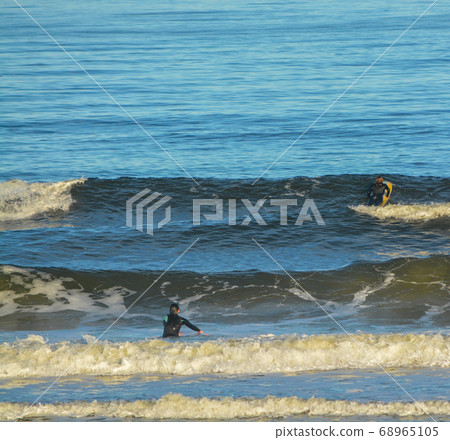 Surfers in the Atlantic, Jacksonville Beach, Duval County, Florida  68965105
