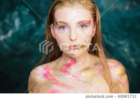 Young charming woman with creative make up Young charming woman with creative make up 68965732