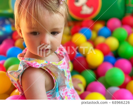 cute little baby girl having fun in the ball pool 68966226
