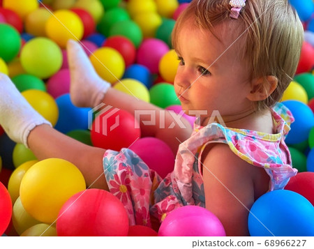 pretty little baby girl having fun in the ball 68966227