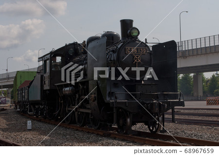 Steam locomotive towing cargo Steam locomotive towing cargo 68967659