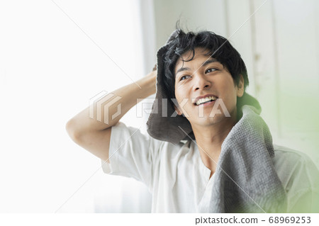 Male washing face 68969253