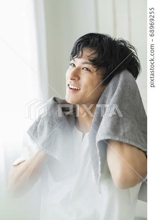 Male washing face 68969255