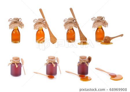 Honey and wooden dipper isolated on white Honey and wooden dipper isolated on white 68969908