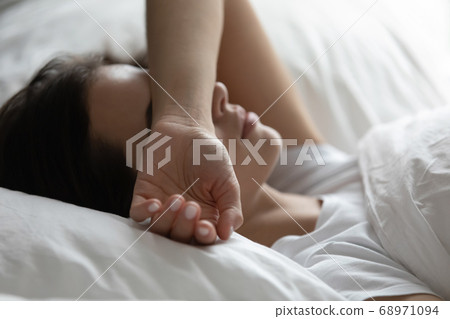 Close up sleepless woman lying in bed, suffering from insomnia 68971094