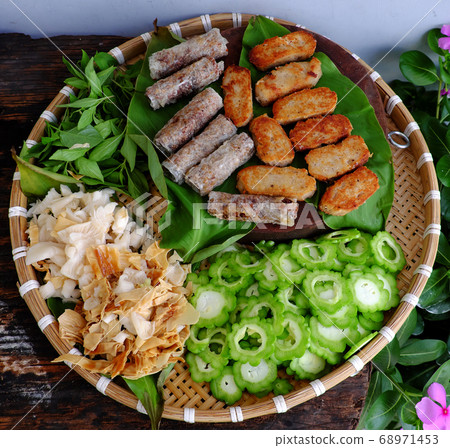 tray of raw material ready to cook vegan meal for lunch, vegetarian meat, spring roll, mushroom, basil, cucumber 68971453