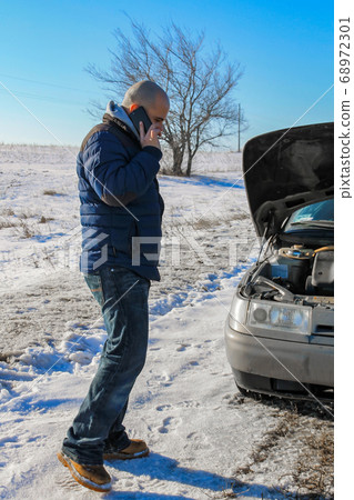 Upset young man calling the car service Upset young man calling the car service 68972301