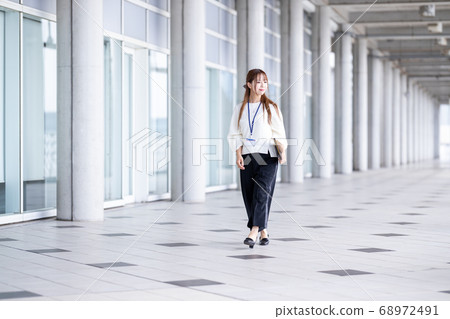 A woman walking in the corridor 68972491