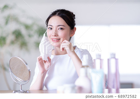 Young woman trying morning mask Young woman trying morning mask 68972582