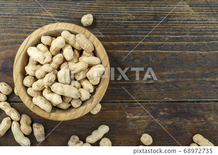 Peanut in a shell texture in a plate. Top view. Peanut in a shell texture in a plate. Top view. 68972735