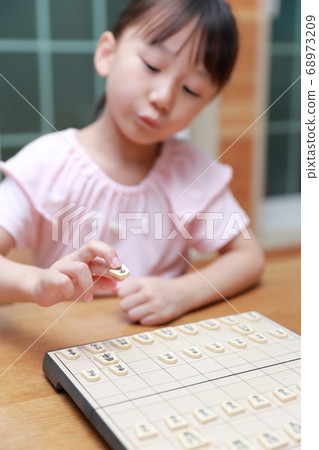 A girl playing shogi 68973209