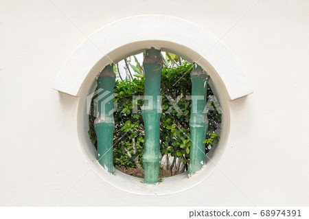 The round hole - window in white wall of public The round hole - window in white wall of public 68974391