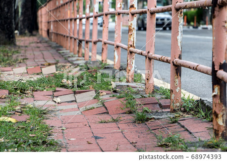Broken walkway in Penang city. Damaged pavement on Broken walkway in Penang city. Damaged pavement on 68974393