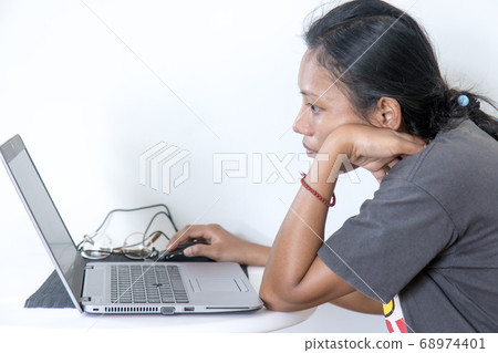 Portrait of Asian woman sitting at a table with 68974401
