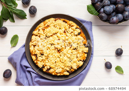 Plum cake on white wooden background, top view Plum cake on white wooden background, top view 68974494