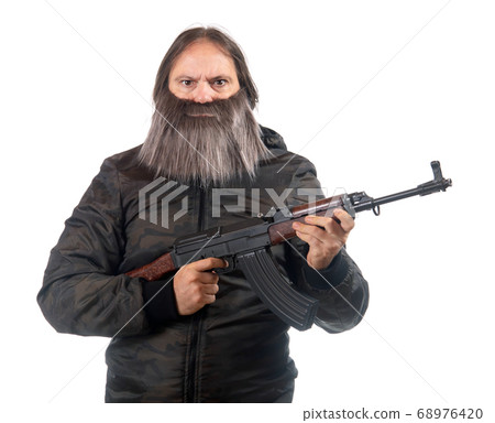 The bearded man armed with kalashnikov isolated on 68976420