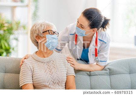 Doctor and senior woman wearing facemasks 68978315