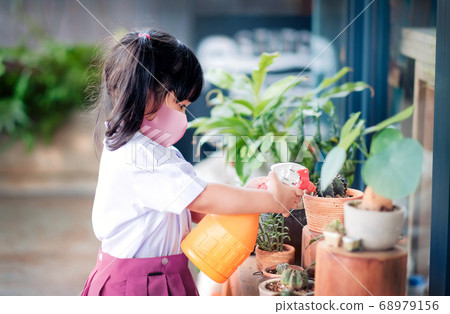 Happy Asian Girl wearing a Surgical Protection 68979156