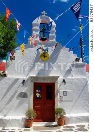 Church surrounded by colorful flags 68979427